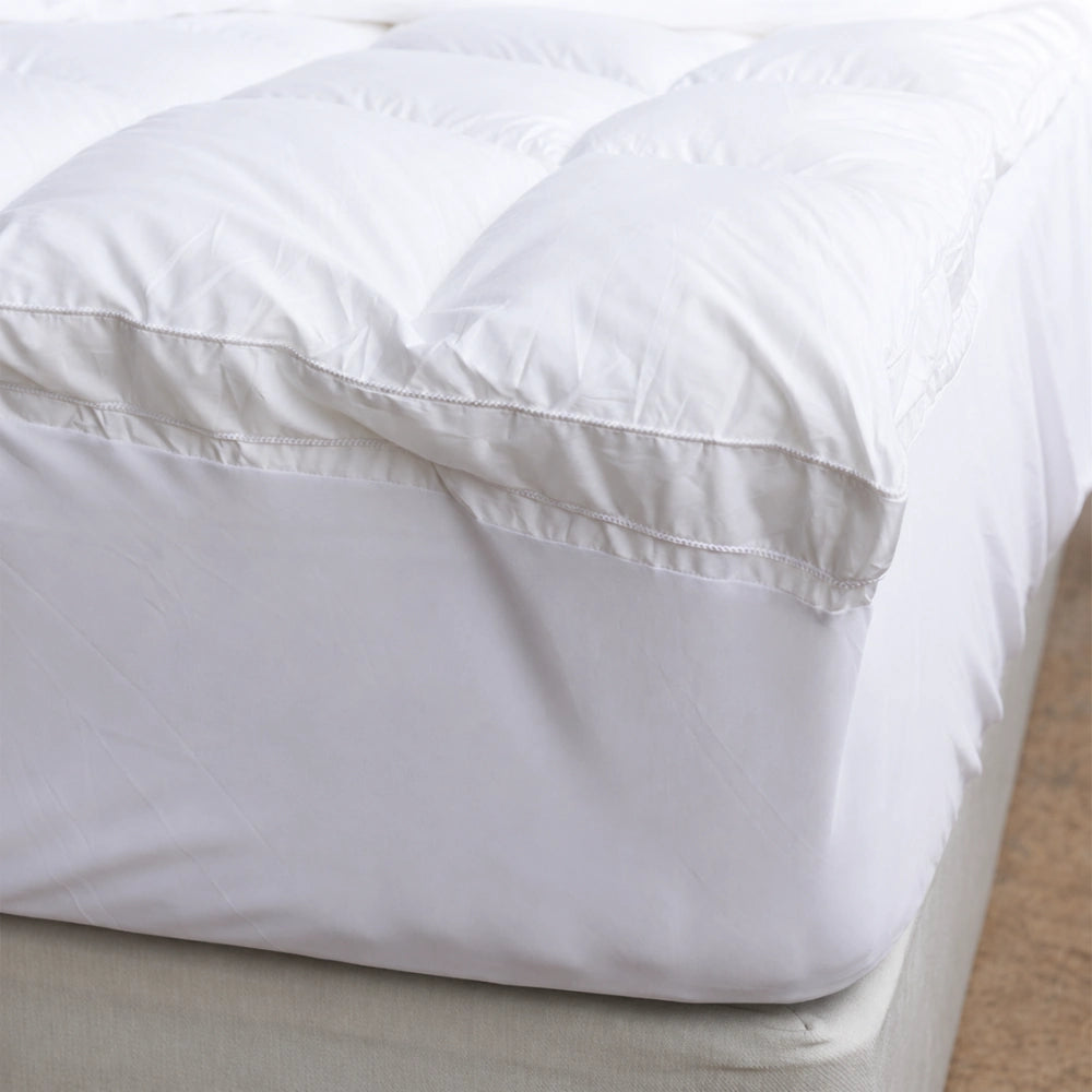 Deep fitted skirt securely wrapping the mattress for a smooth bamboo topper fit.