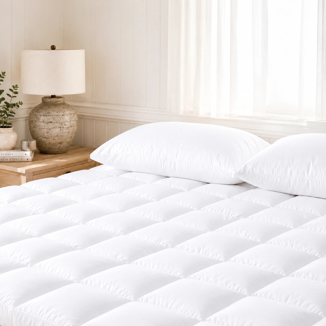 Soft quilted mattress topper adding extra comfort to a neatly made bed.
