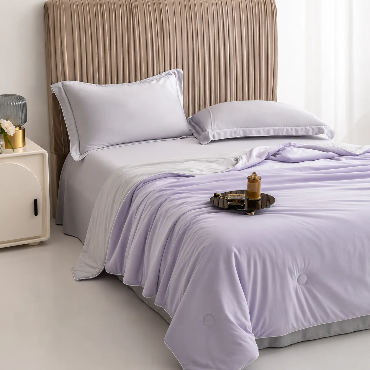Lavender Haze cooling blanket styled on an upholstered bedroom bed