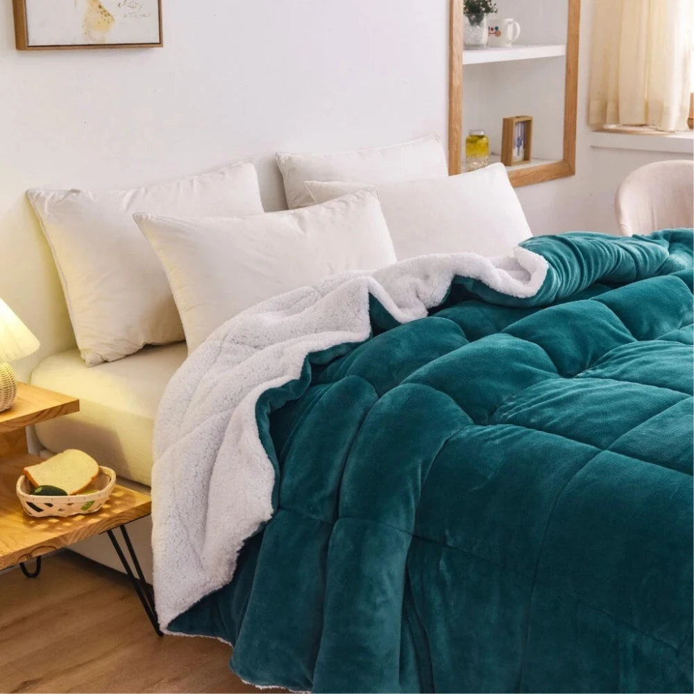 teal fleece quilt draped across bed adding plush warm bedding