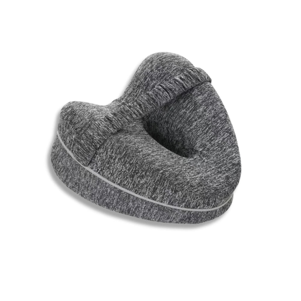 Grey contour pillow designed for leg support and sciatica relief