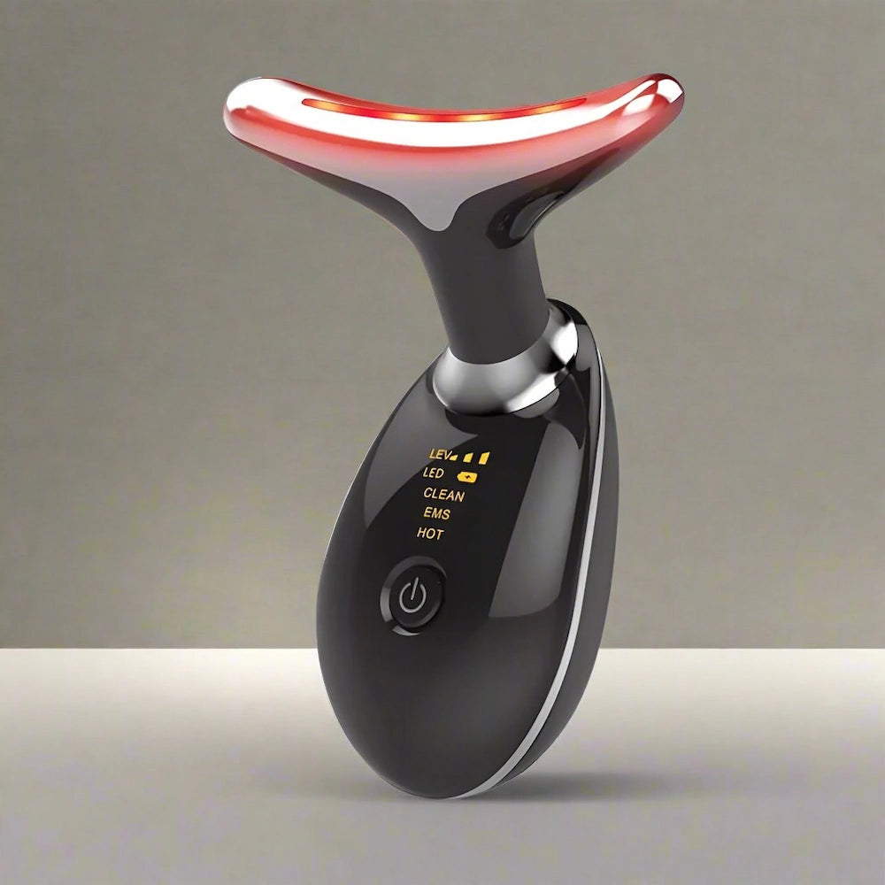 Black handheld device lit up for anti ageing skincare treatment