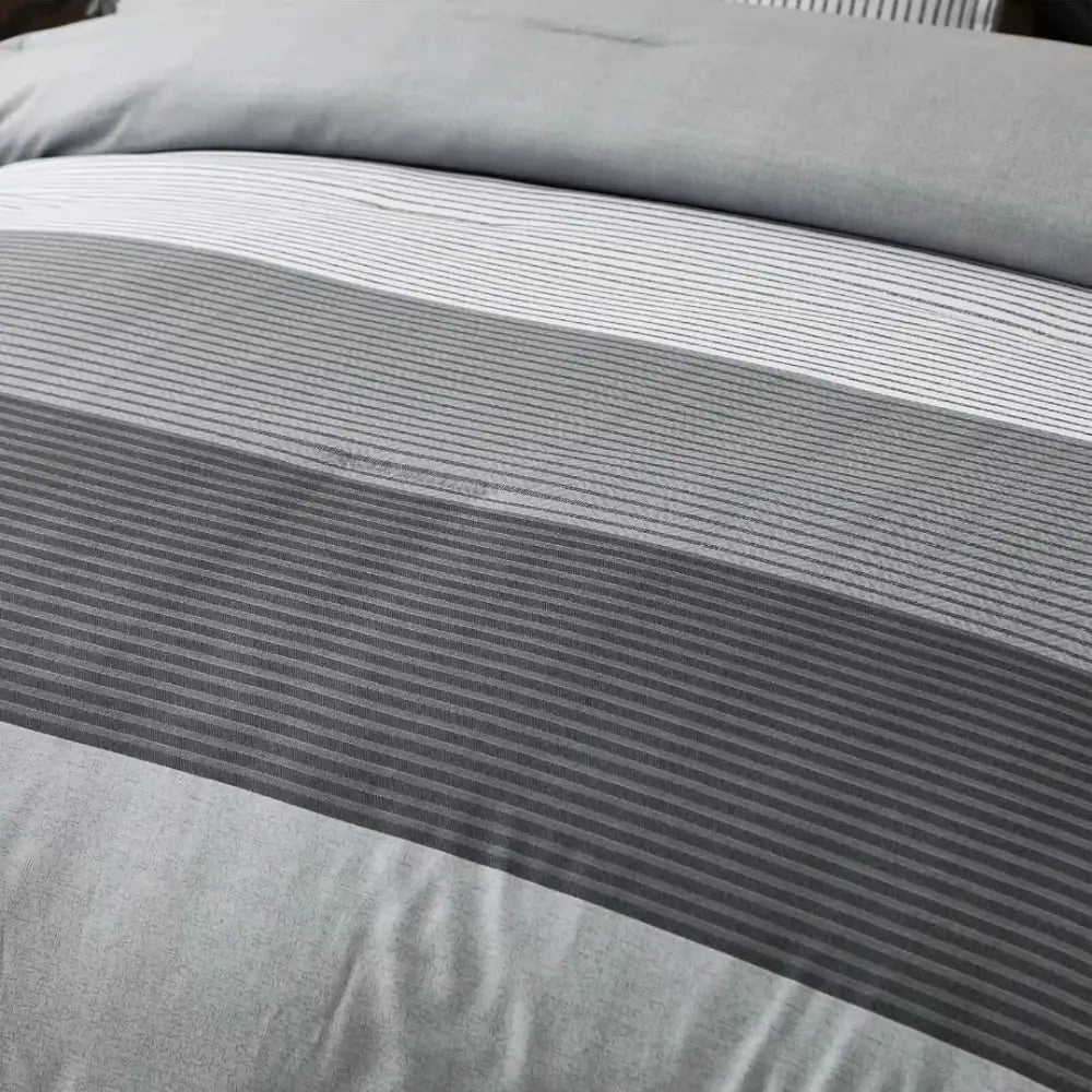 Grey stripe comforter showing its modern contrasting panel design