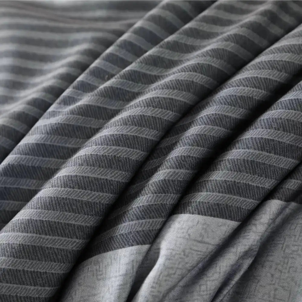 Close-up of soft grey striped summer comforter fabric
