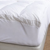 Deep fitted skirt securely wrapping the mattress for a smooth bamboo topper fit.