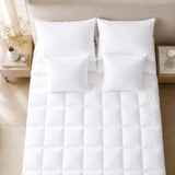 Top-down view of a fitted bamboo mattress topper with matching pillows.