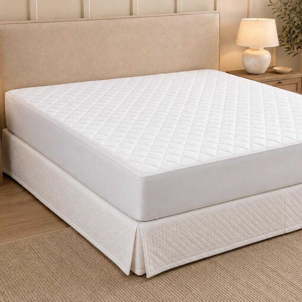 Premium cotton mattress protector fitted to a modern bedroom setting