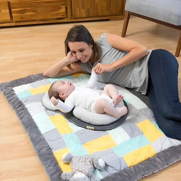 Mother playing with baby using a head shaping pillow designed to prevent flat head syndrome and support healthy infant development during rest and play.