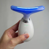 Blue light neck massager in use for anti ageing skin treatment