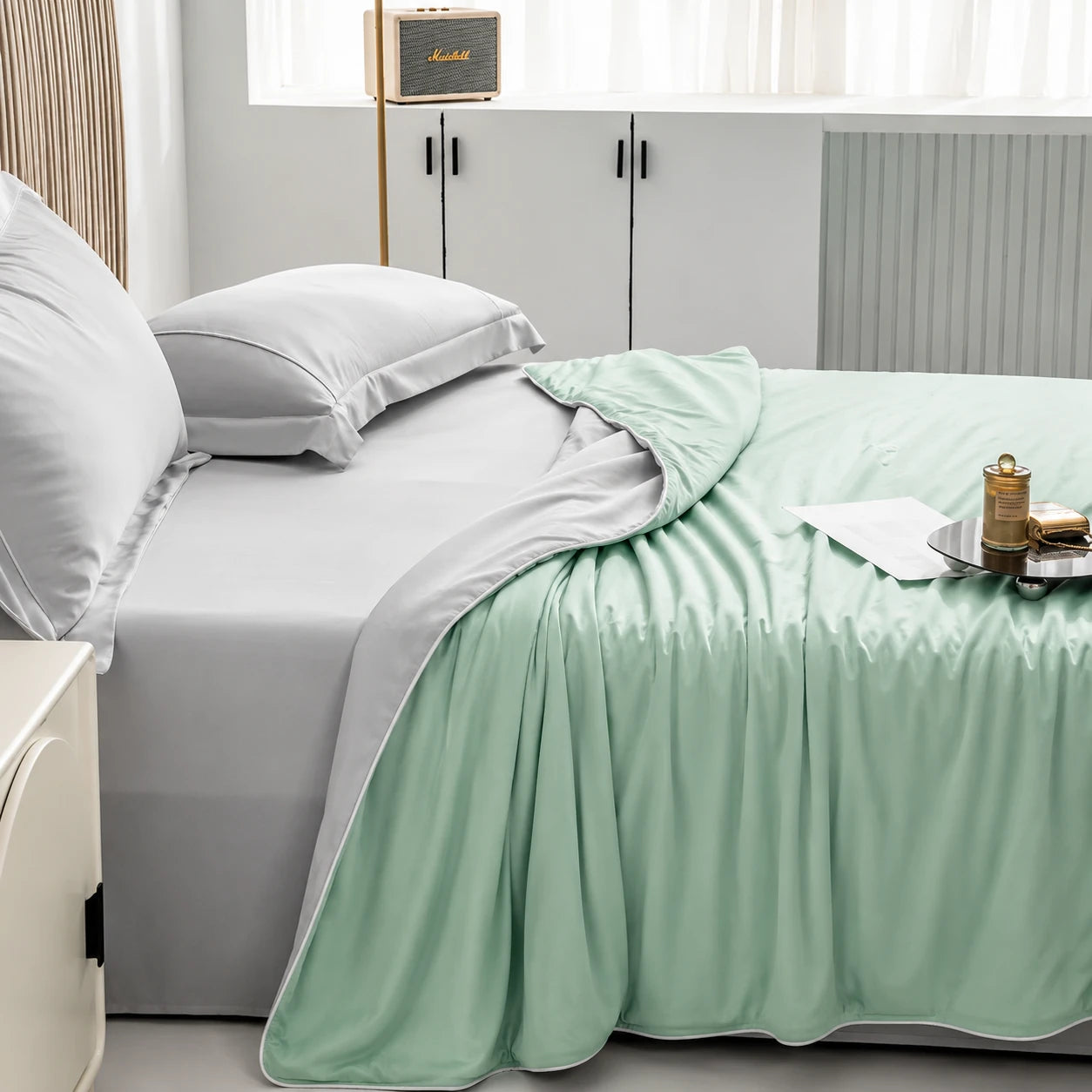 Aqua Green cooling blanket layered across a modern bedroom bed