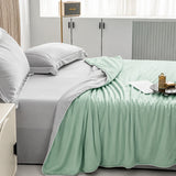 Aqua Green cooling blanket layered across a modern bedroom bed