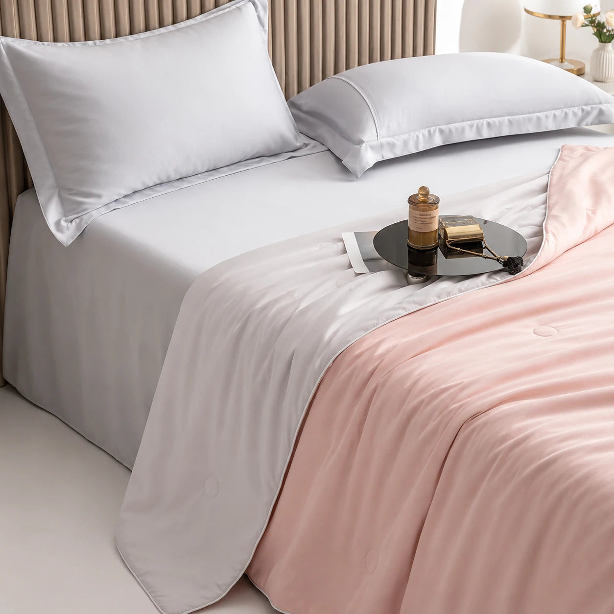 Blush Pink cooling blanket draped across a luxury bed setting