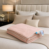 Folded Blush Pink cooling blanket styled on a premium bedroom bed