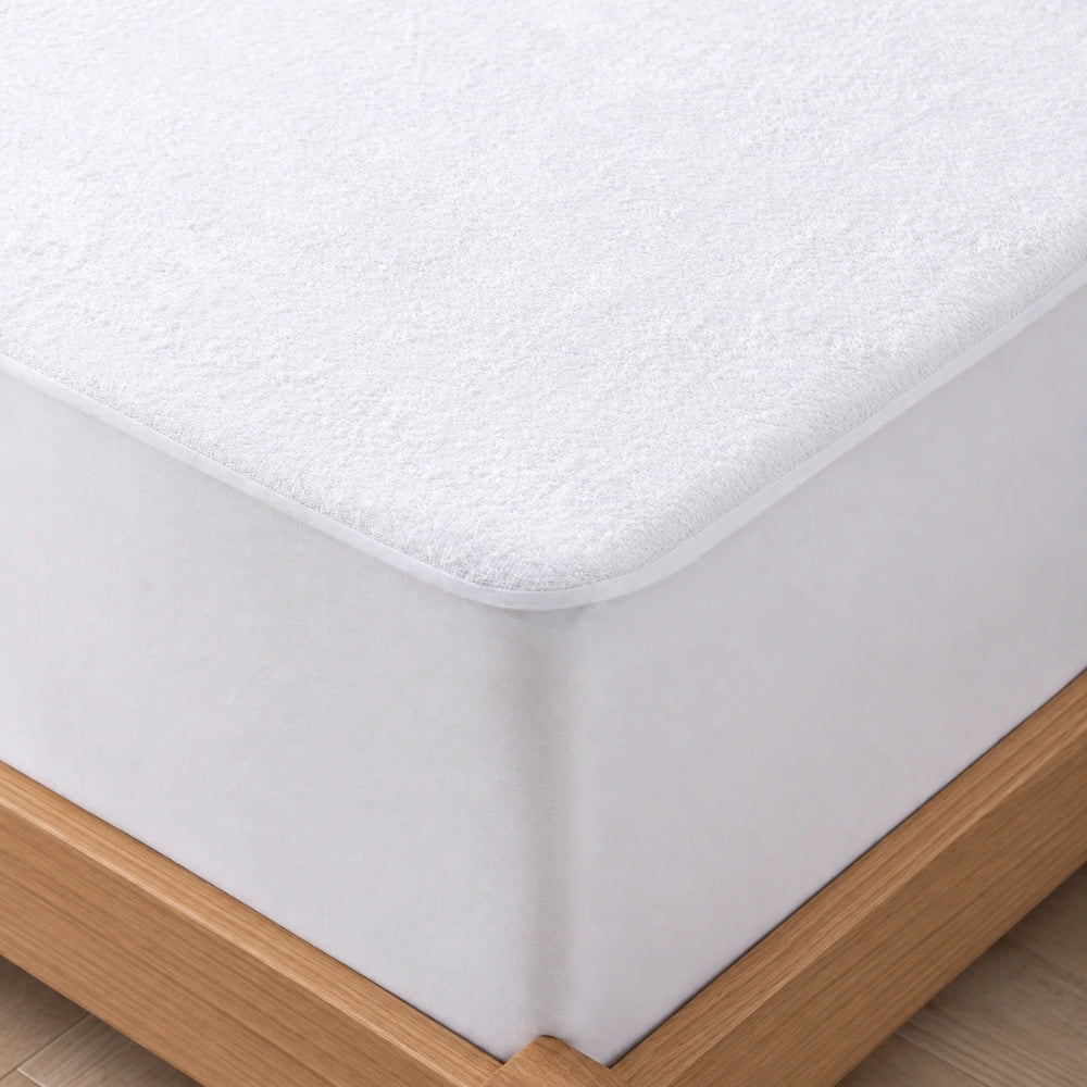 DreamGuard Waterproof Mattress Protector fitted securely over a mattress