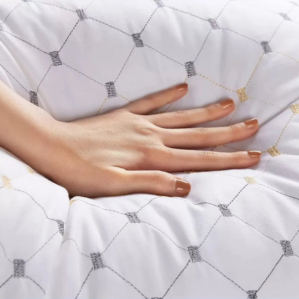 Close-up of hand testing DreamHaven memory support pillow design