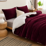 Burgundy sherpa quilt cover styled on a warm winter bed