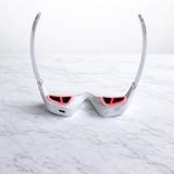 Eye massager displayed with product box on marble