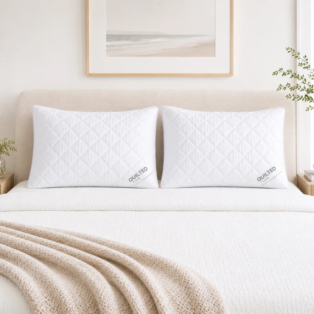 Quilted pillows displayed on modern bed with soft neutral styling