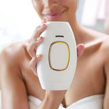 Handheld IPL device held in hand for at home smooth skin hair removal