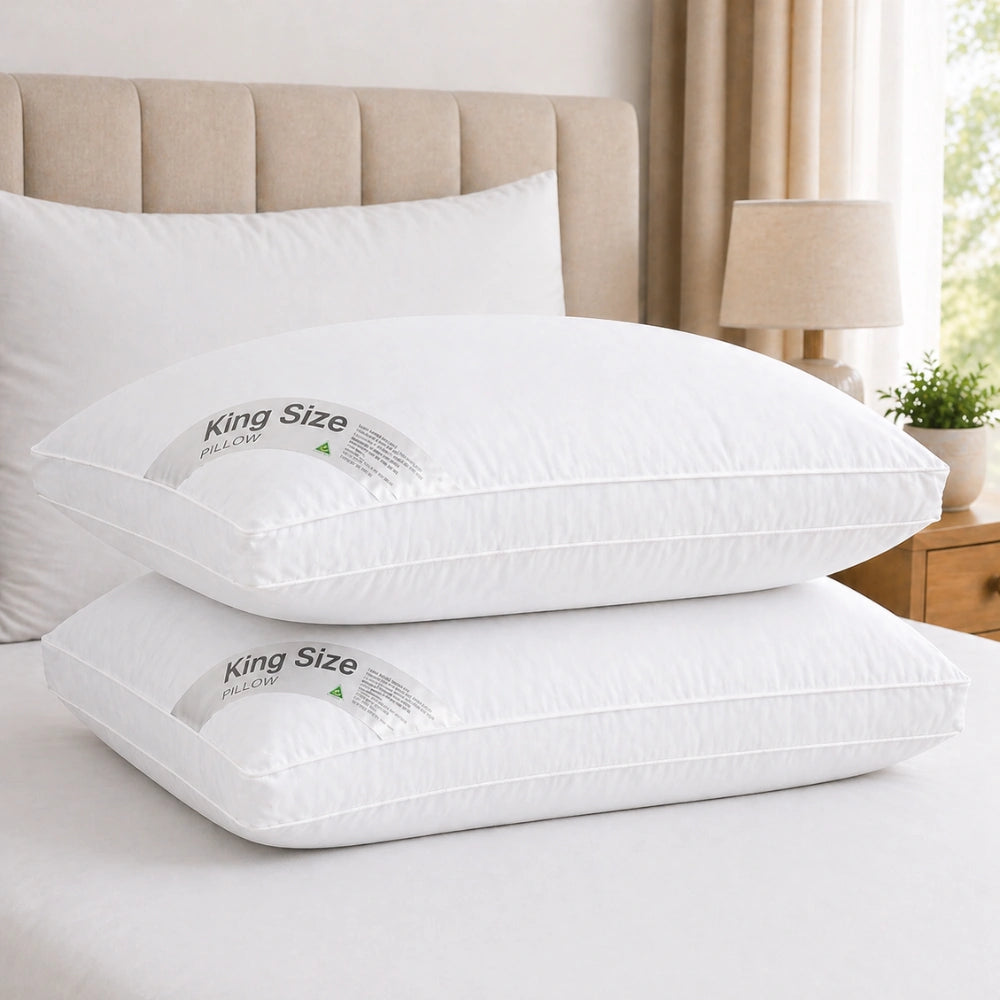stacked pillows on a bed creating a plush hotel pillow look
