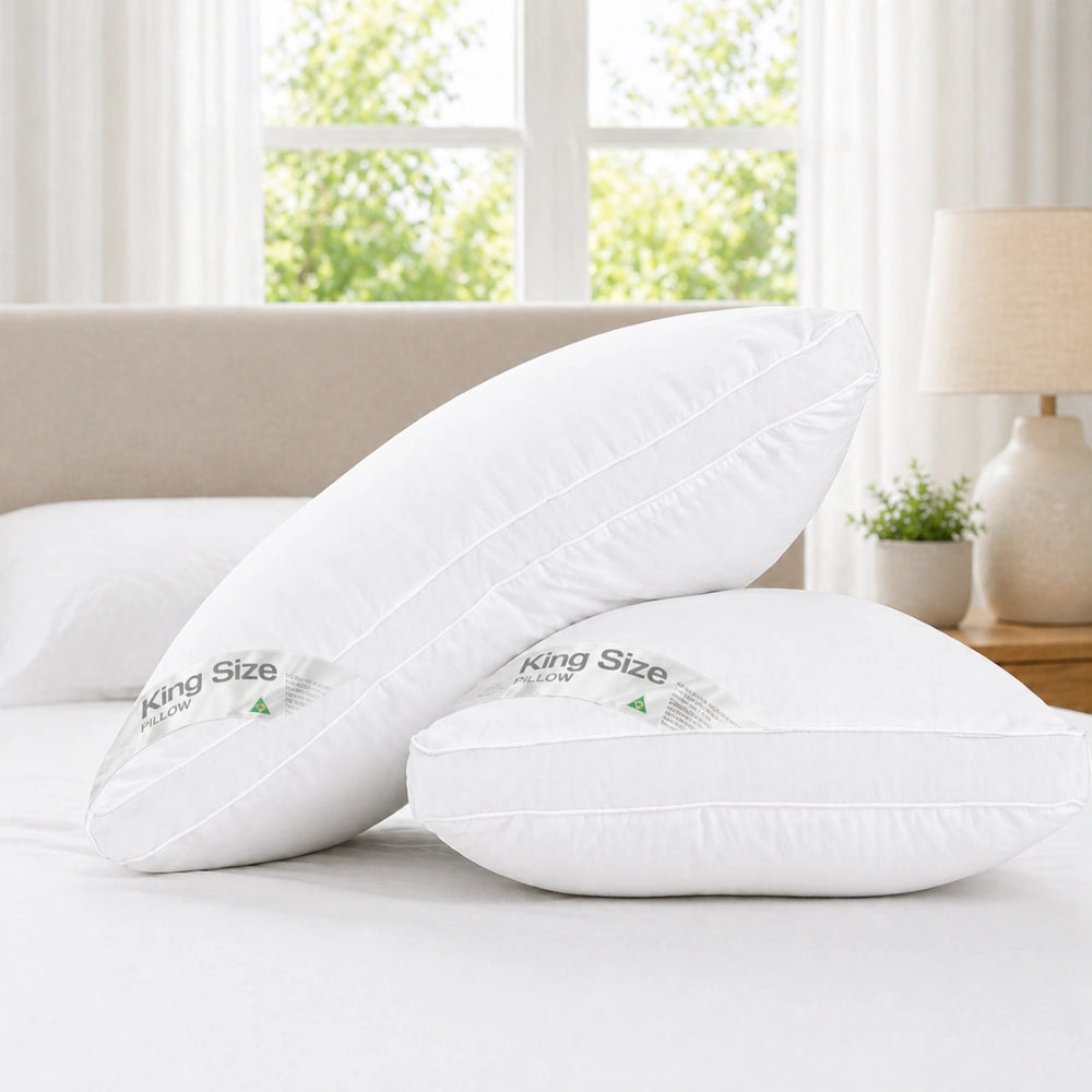 two pillows styled on a bed in a bright room for hotel pillow comfort
