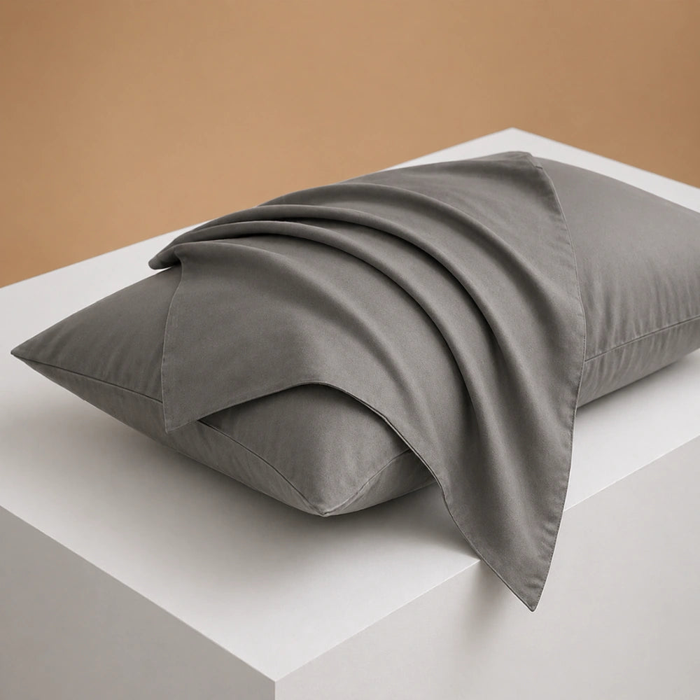 stone grey pillowcase draped over pillow showing smooth breathable cotton texture