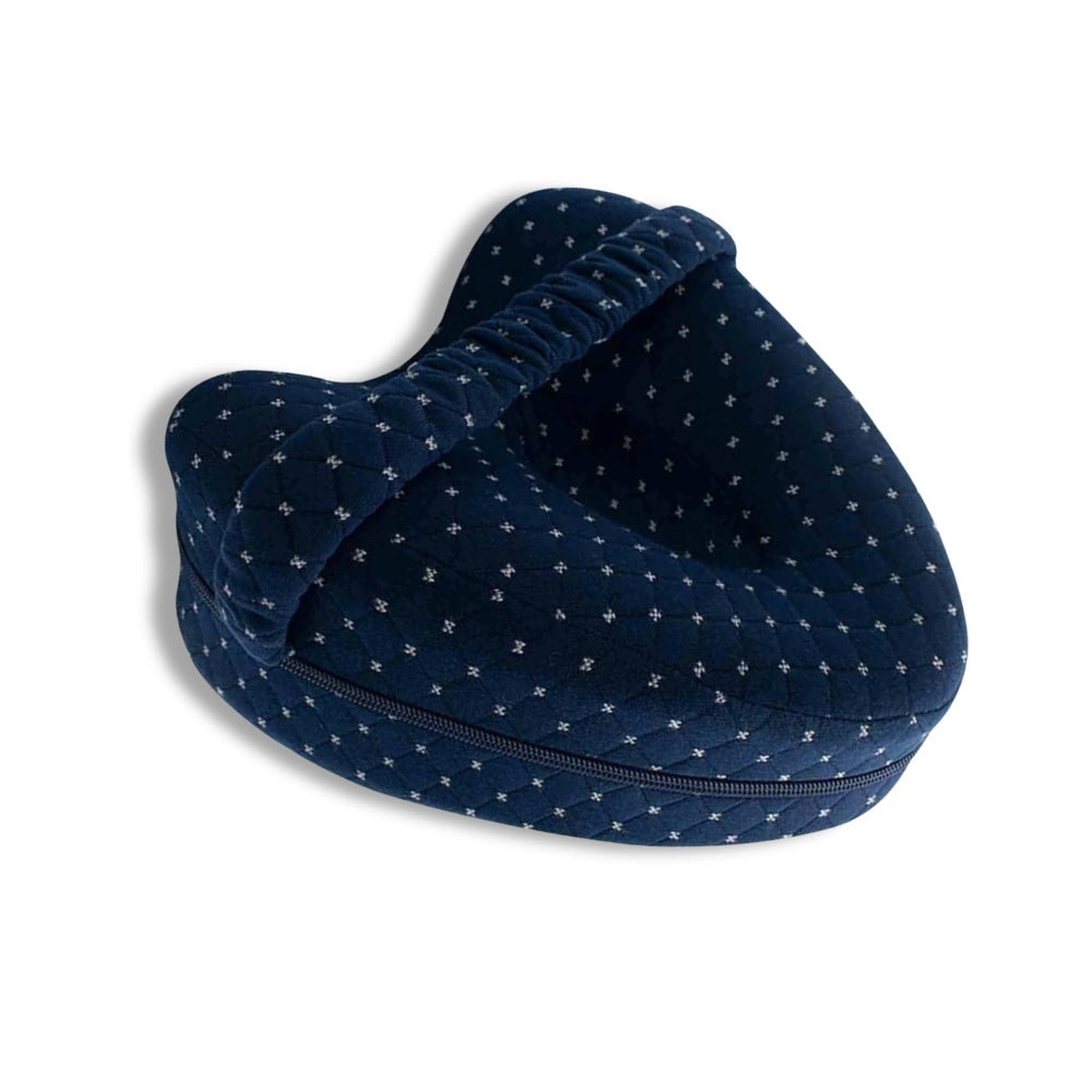 Dark blue pillow positioned for side sleeping and hip alignment support