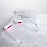 LED eye therapy massager glasses on marble background
