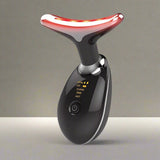 Black handheld device lit up for anti ageing skincare treatment