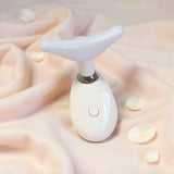 LED neck massager resting on soft fabric for skin firming treatment