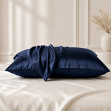 Navy silk pillowcases styled on a bed with silk pillowcases