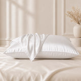 White silk pillowcases styled in a bedroom with silk pillowcases