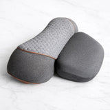 Curved pillow shown from above on marble surface for neck massager use