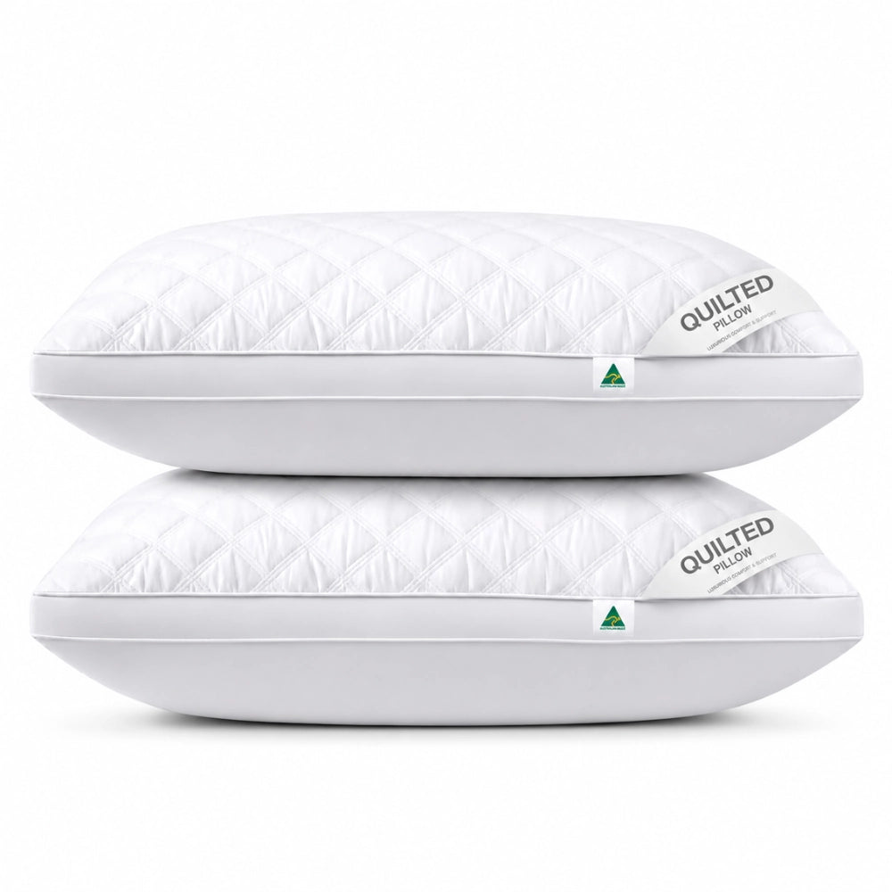 Quilted twin pack white pillows with soft diamond stitching on a clean white background