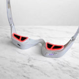 LED eye massager resting on marble bench with mode buttons