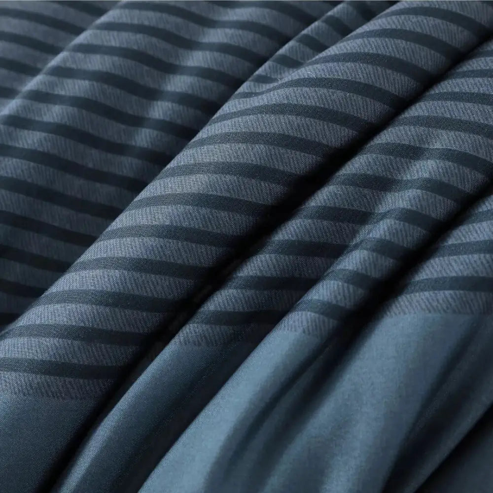 Close-up of soft blue striped summer comforter fabric