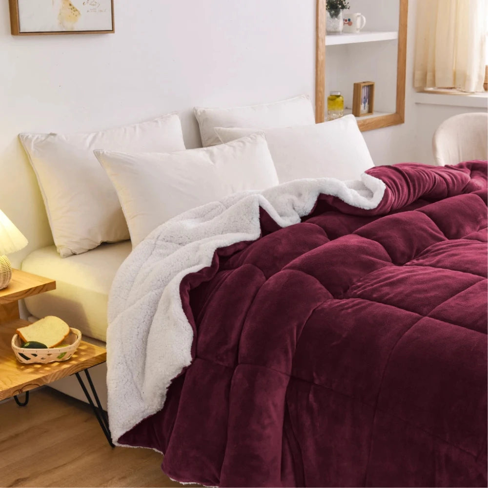 burgundy fleece quilt layered on bed creating warm cosy bedroom feel
