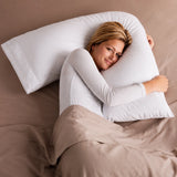 Woman sleeping comfortably while hugging a V pillow in bed